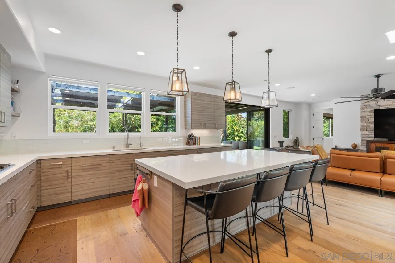 1180 Devonshire Drive Encinitas, CA 92024 - Photo 12 of 53 a kitchen with stainless steel appliances granite countertop a kitchen island a stove and a sink
