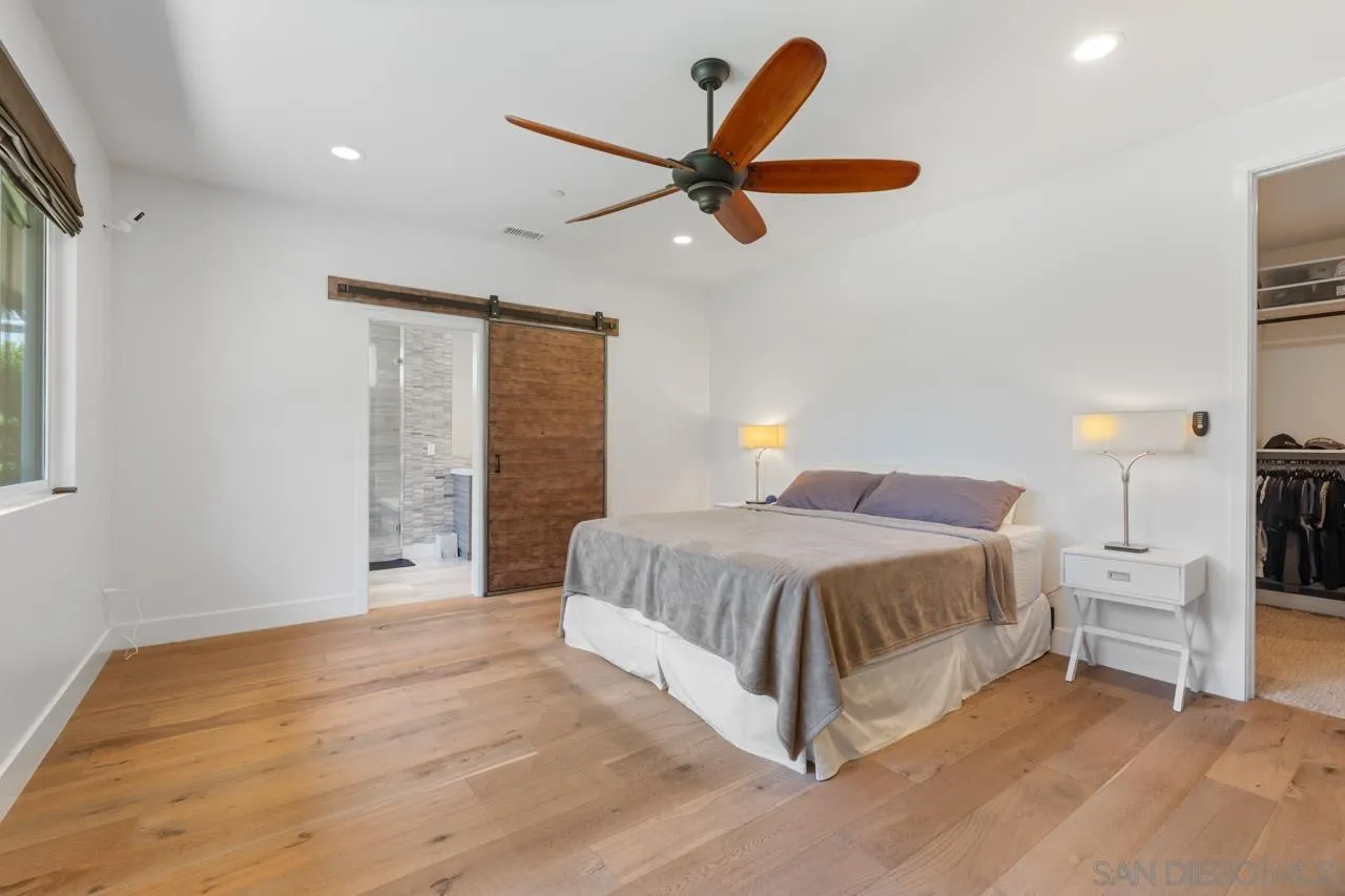 1180 Devonshire Drive Encinitas, CA 92024 - Photo 24 of 53 a spacious bedroom with a bed and a large window