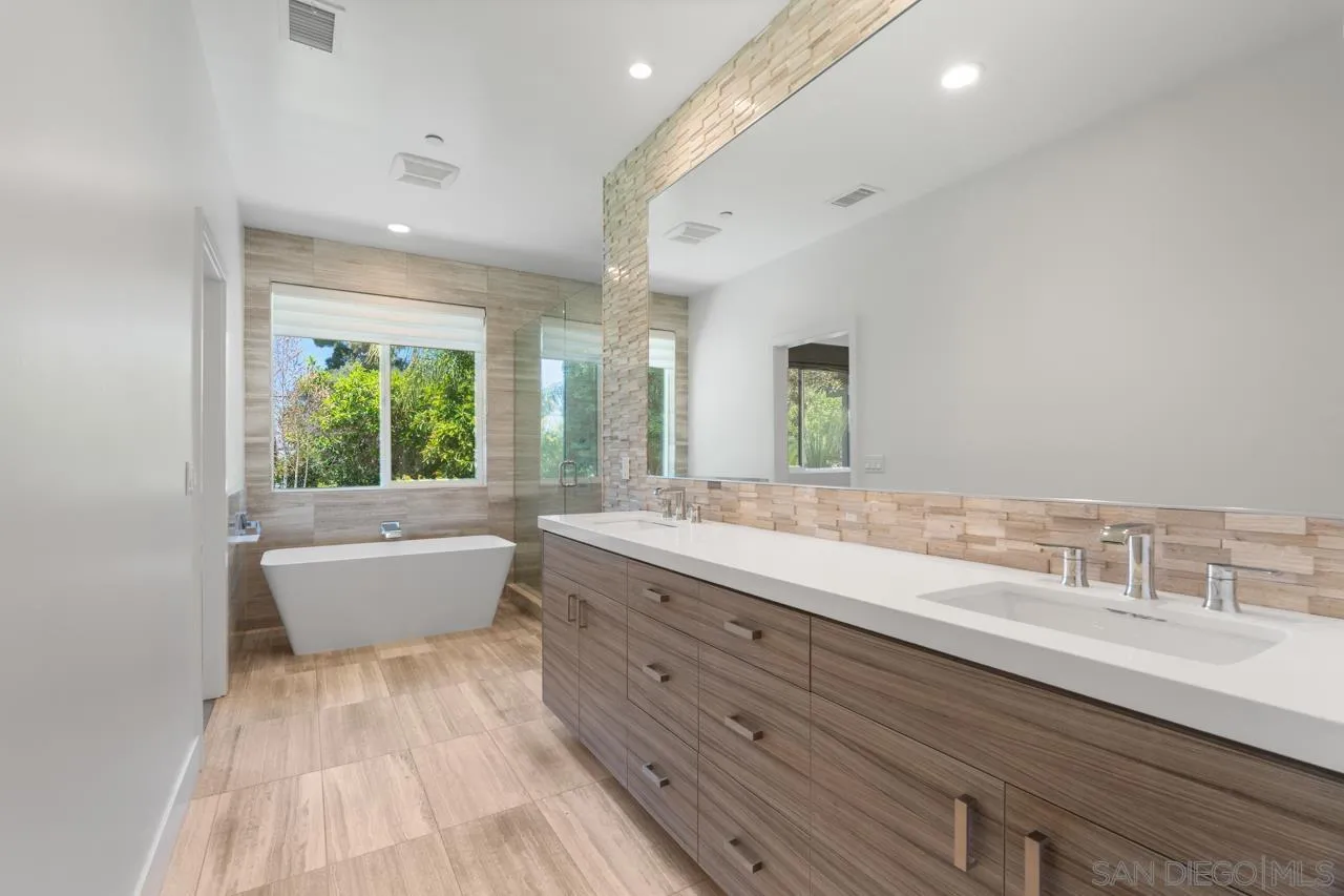1180 Devonshire Drive Encinitas, CA 92024 - Photo 28 of 53 a bathroom with a granite countertop sink mirror and a bathtub
