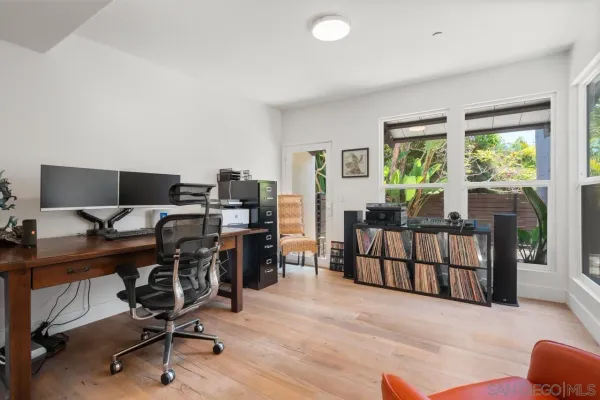 a view of a livingroom with workspace and a couch