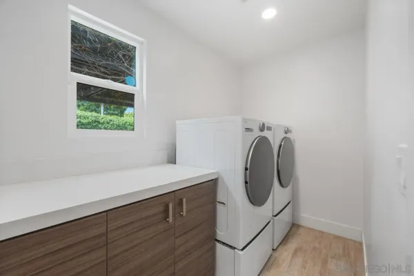 a bathroom with a sink a toilet a mirror and shower