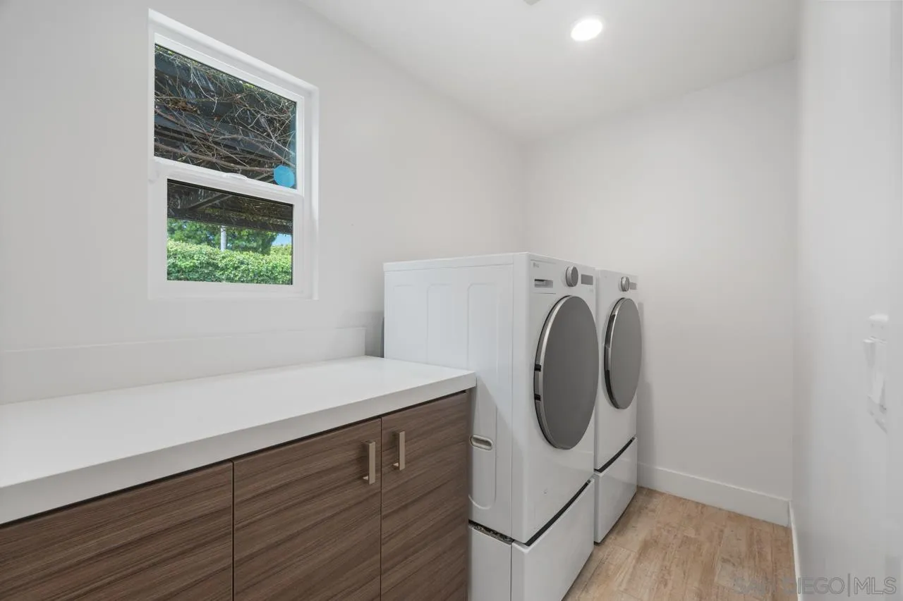 1180 Devonshire Drive Encinitas, CA 92024 - Photo 33 of 53 a utility room with a sink a washer and dryer