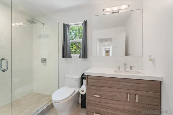 a bathroom with a shower and toilet