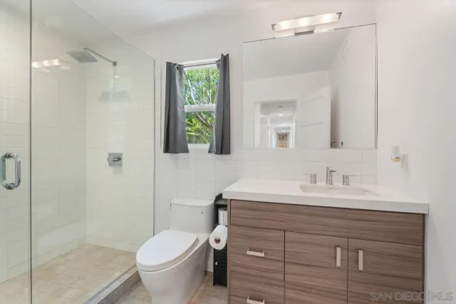 a bathroom with a shower and toilet