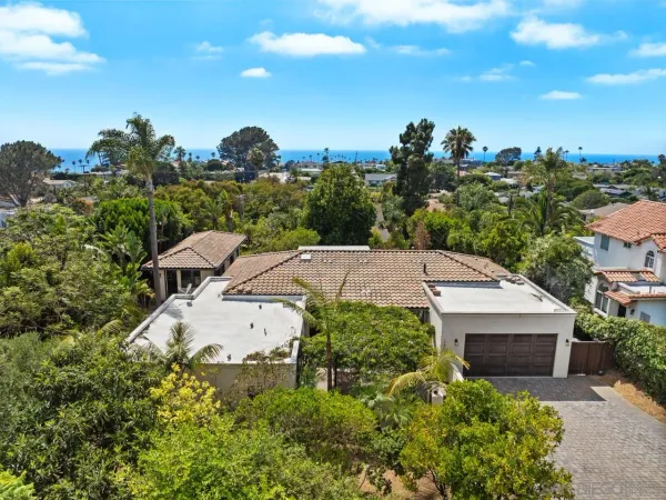 an aerial view of a residential houses with city view