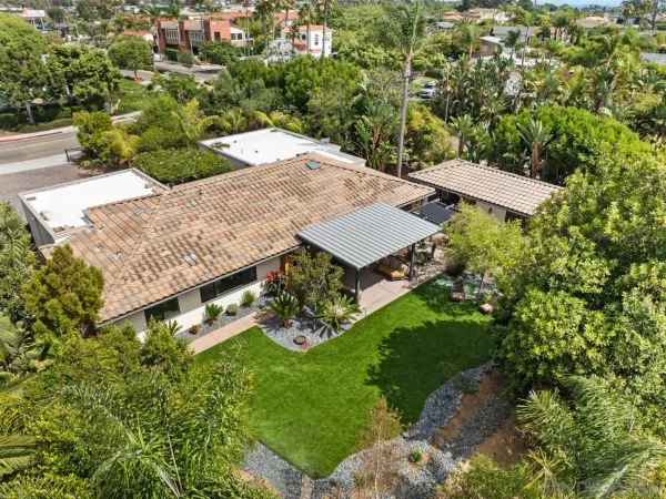 an aerial view of a house with outdoor space and street view