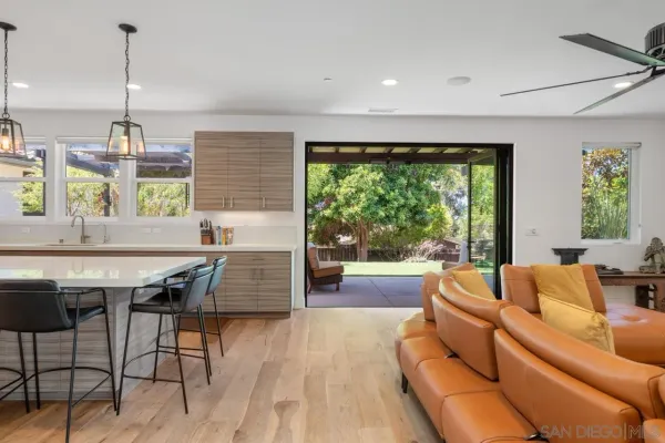 a living room with furniture and a floor to ceiling window