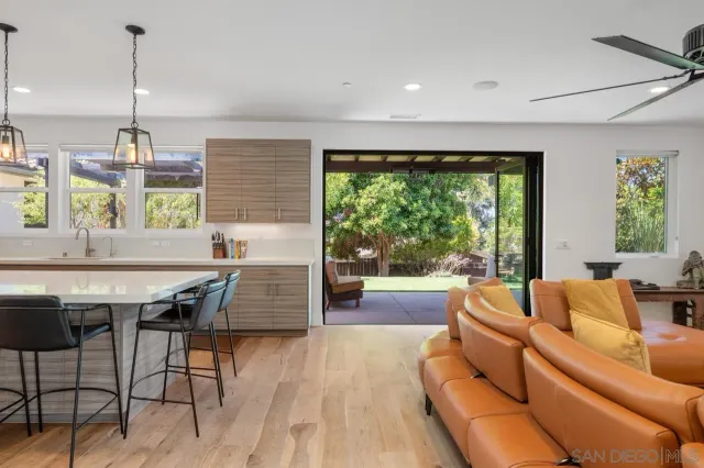 a living room with furniture and a floor to ceiling window