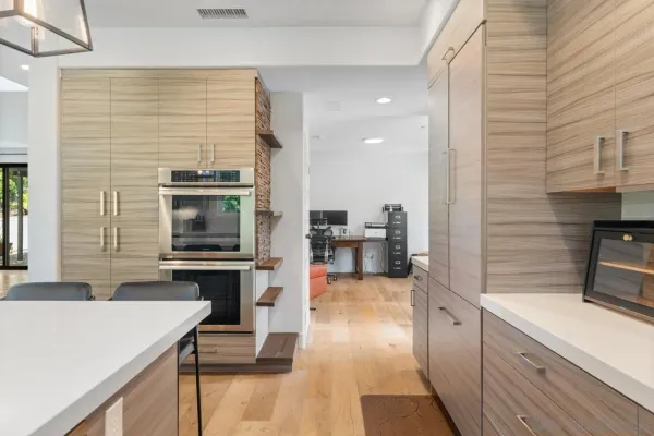 a kitchen with stainless steel appliances kitchen island granite countertop a stove a sink and a refrigerator