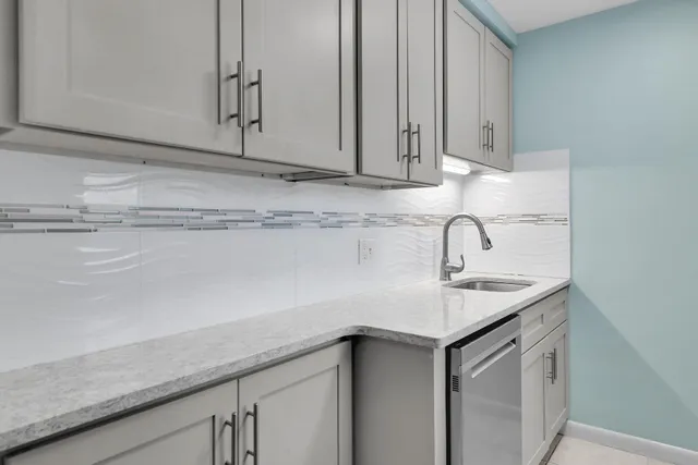 a kitchen with stainless steel appliances granite countertop a sink a stove and a microwave