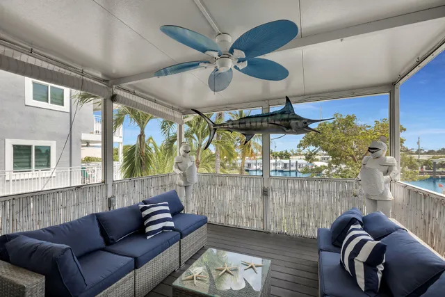 a living room with furniture a window and a chandelier