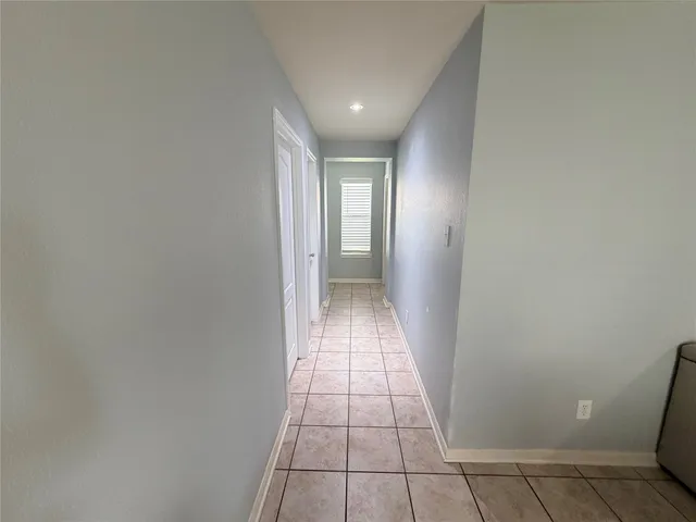 a view of hallway with a window and a mirror