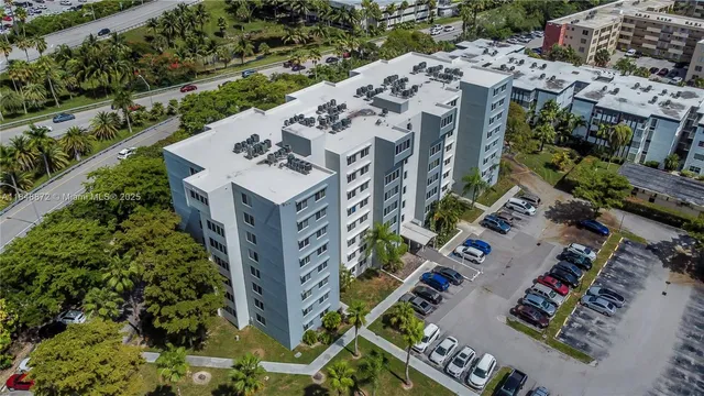 a view of a large room with wooden floor and furniture