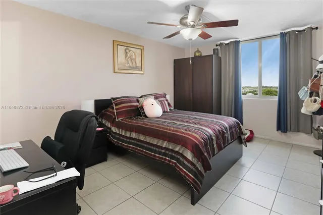 a bedroom with a bed and a flat tv screen