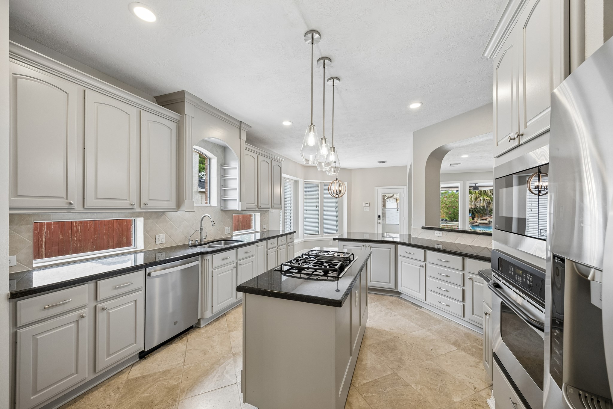 6331 Collina Springs Court Houston, TX 77041 - Photo 11 of 34 a kitchen with stainless steel appliances granite countertop a sink stove and refrigerator