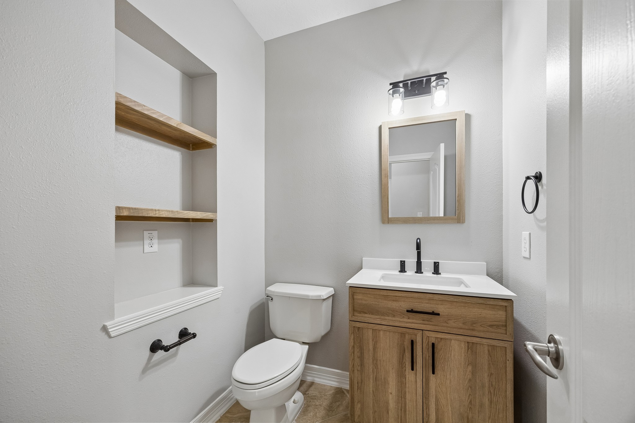 6331 Collina Springs Court Houston, TX 77041 - Photo 13 of 34 a bathroom with a toilet sink vanity and mirror