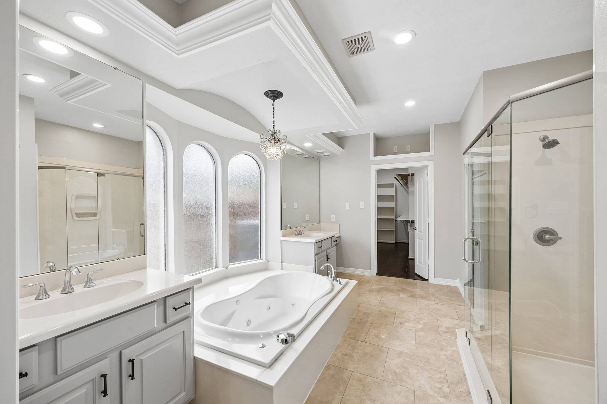 6331 Collina Springs Court Houston, TX 77041 - Photo 17 of 34 a spacious bathroom with a tub sink shower and mirror