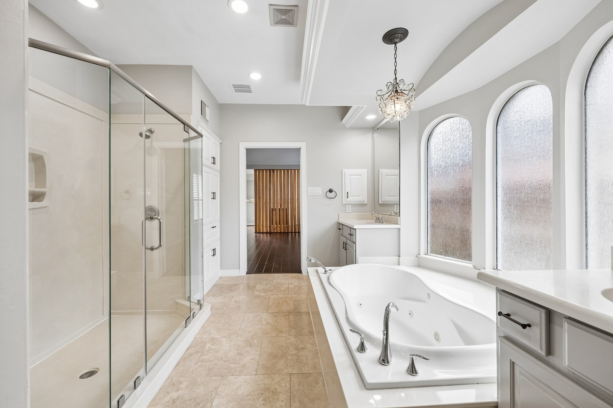 6331 Collina Springs Court Houston, TX 77041 - Photo 18 of 34 a spacious bathroom with a granite countertop sink a mirror a bathtub and shower