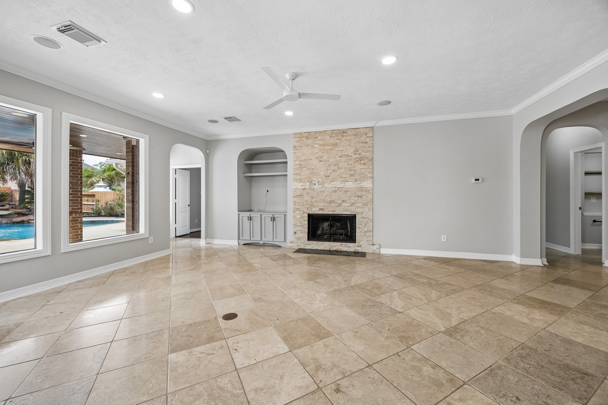 6331 Collina Springs Court Houston, TX 77041 - Photo 7 of 34 an empty room with windows and fireplace