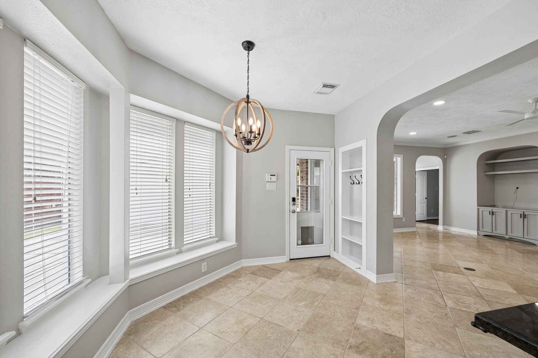 6331 Collina Springs Court Houston, TX 77041 - Photo 9 of 34 a view of an empty room with glass door and windows