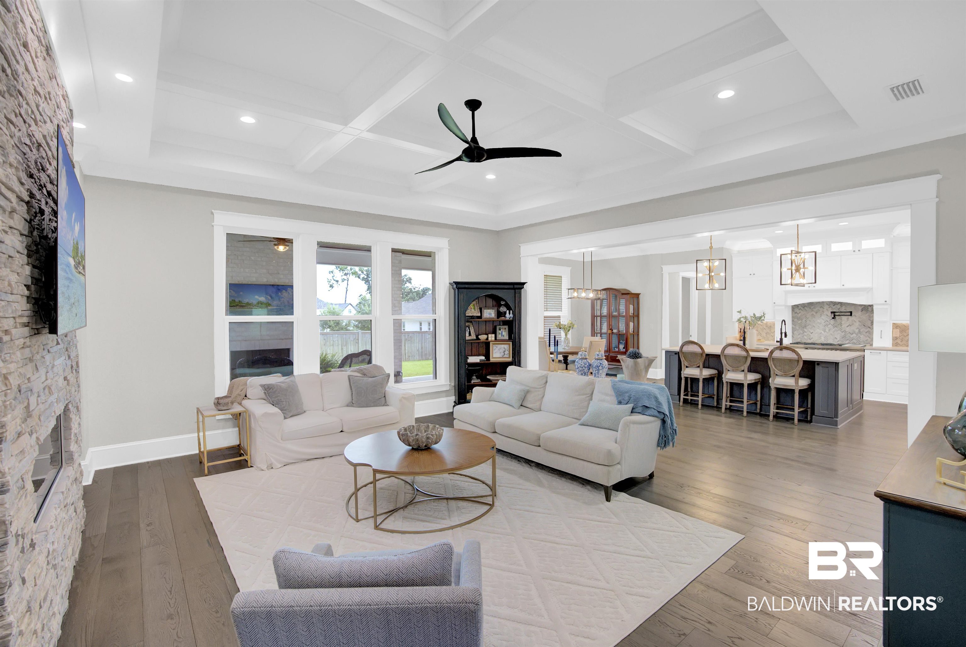 10940 Atrium Avenue Fairhope, AL 36532 - Photo 7 of 43 Living room with beam ceiling, coffered ceiling, hardwood / wood-style floors, a fireplace, and ceiling fan with notable chandelier