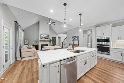 a kitchen with granite countertop white cabinets and white appliances