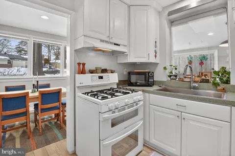 a kitchen with cabinets appliances and a counter top space