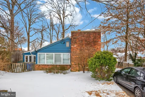 a view of a house with a snow in the yard