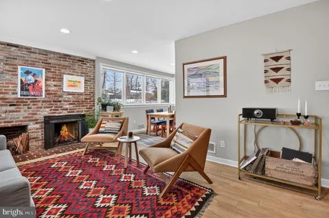 a living room with furniture a rug and a fireplace