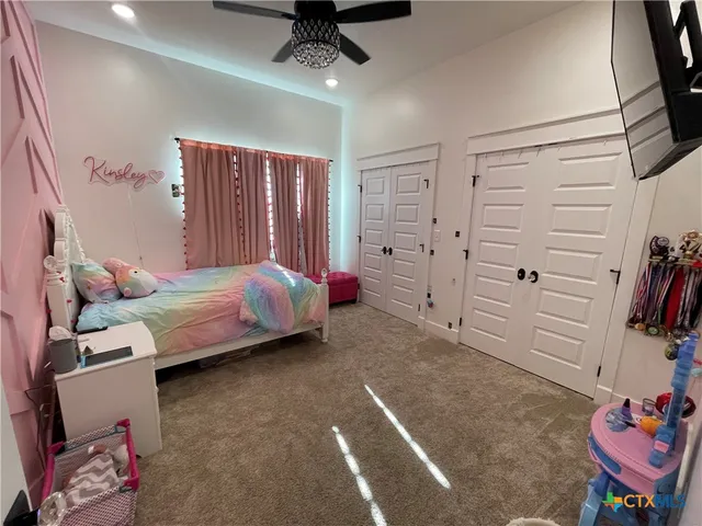 a bedroom with a bed and cabinets
