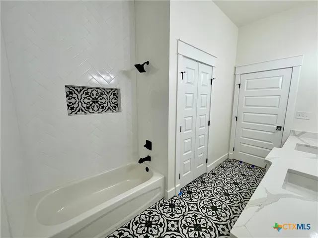 a bathroom with a bathtub and a shower