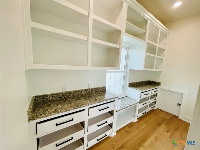 a kitchen with a cabinets and window