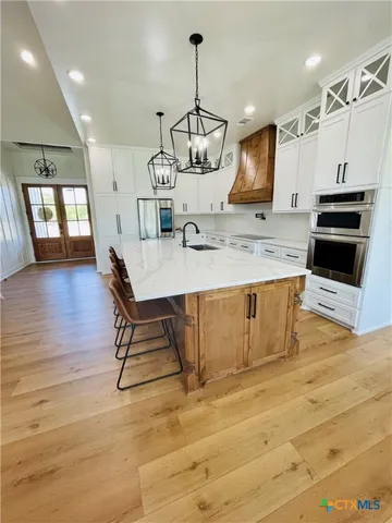 a view of a kitchen with a sink stainless steel appliances and cabinets