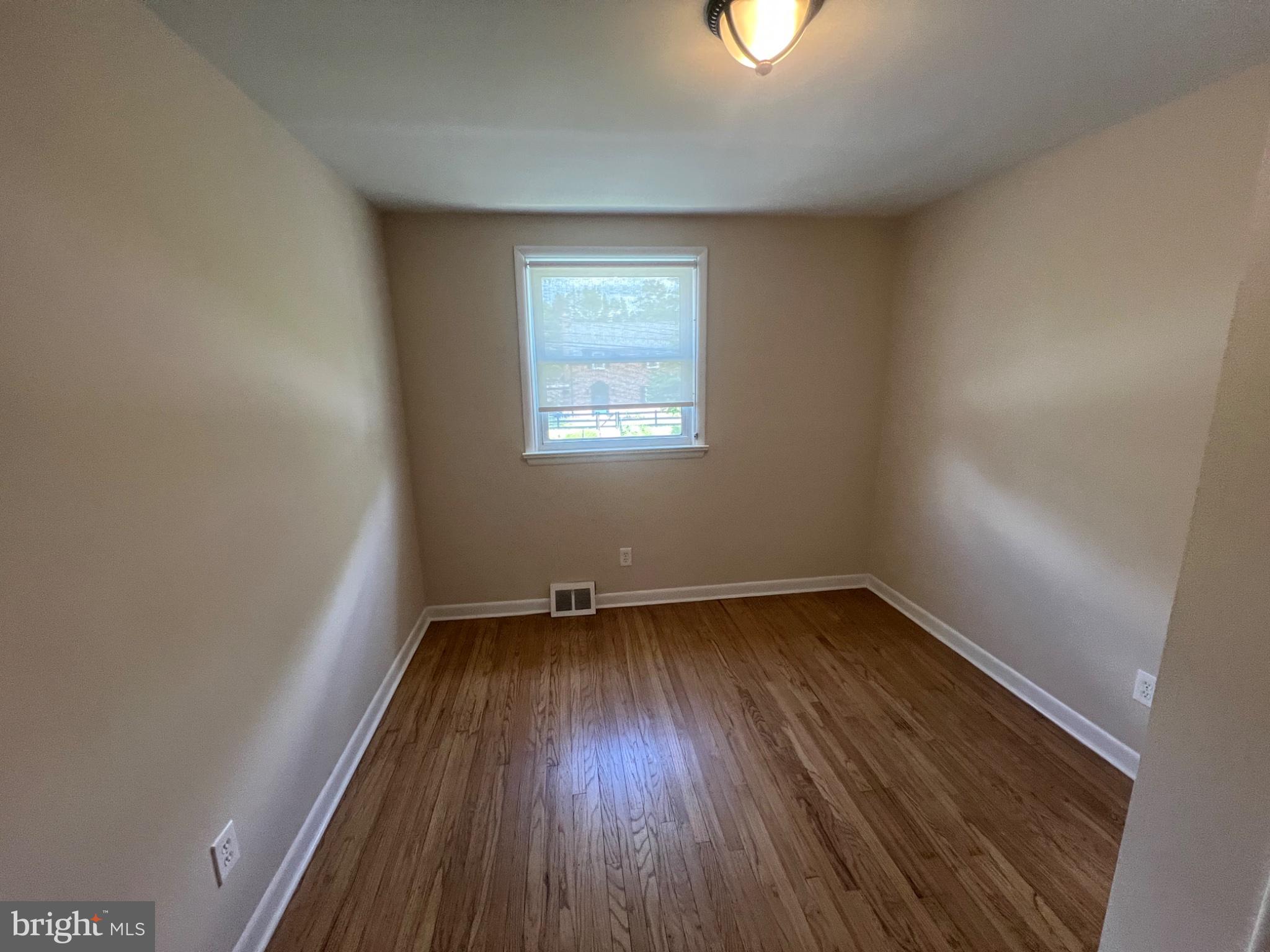 20 Fairview Road Swarthmore, PA 19081 - Photo 22 of 24 an empty room with a hardwood and windows