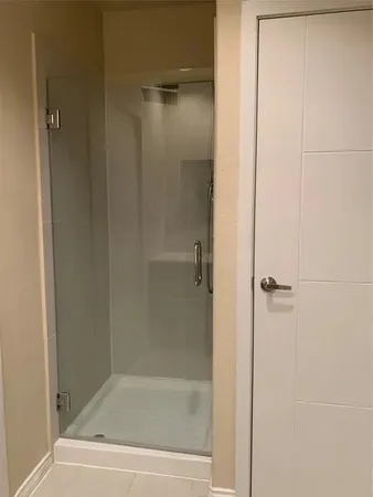 a bathroom with a glass shower door