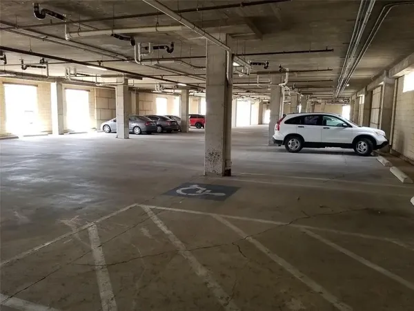 a view of parking garage with cars parked