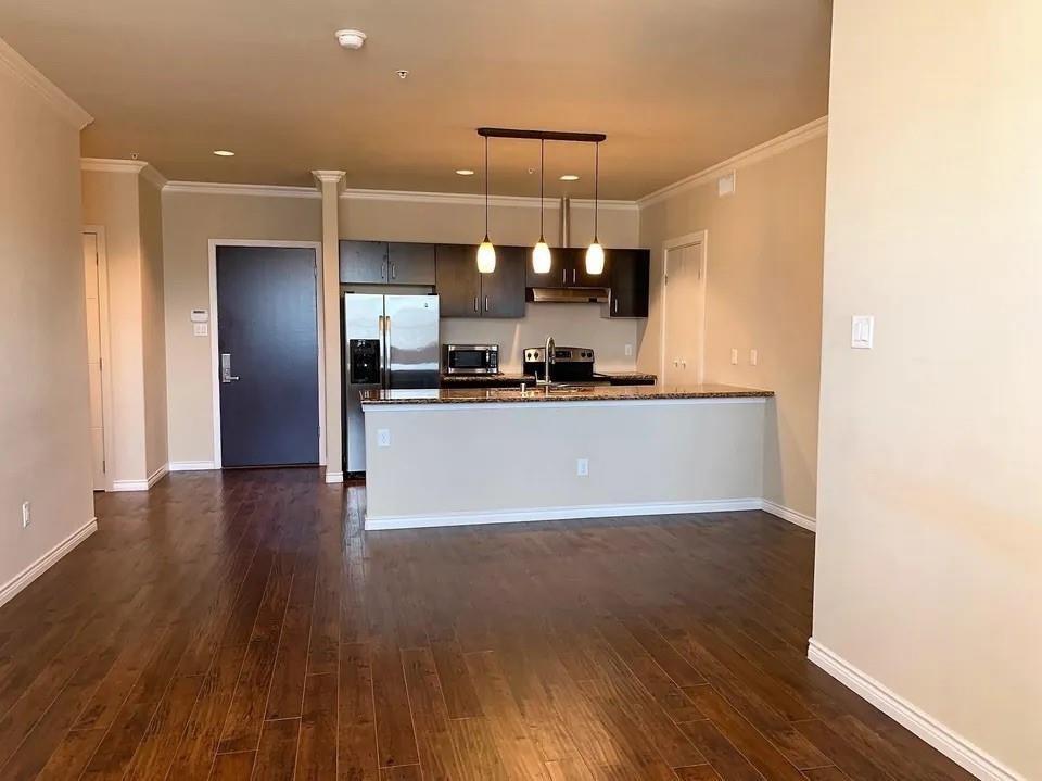 1100 West Trinity Mills Road, Unit 2025 Carrollton, TX 75006 - Photo 3 of 16 a view of a kitchen with a sink and a refrigerator