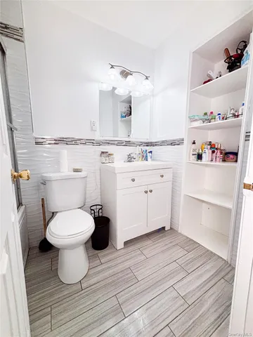 a bathroom with a sink toilet and a mirror