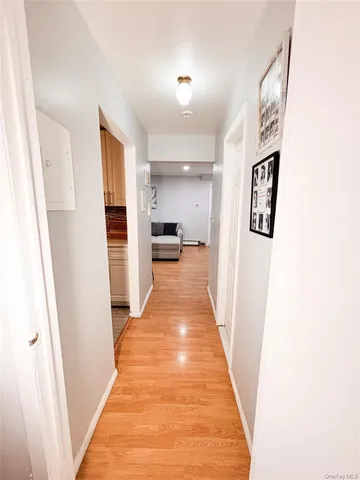 a view of a hallway with wooden floor