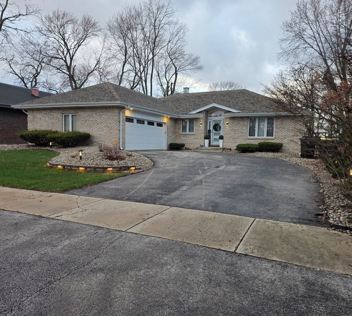 1844 180th Place Lansing, IL 60438 - Photo 1 of 34 a front view of a house with a yard and garage