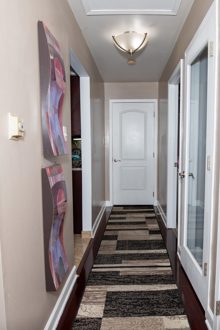 1844 180th Place Lansing, IL 60438 - Photo 19 of 34 a view of a hallway with wooden floor and stairs