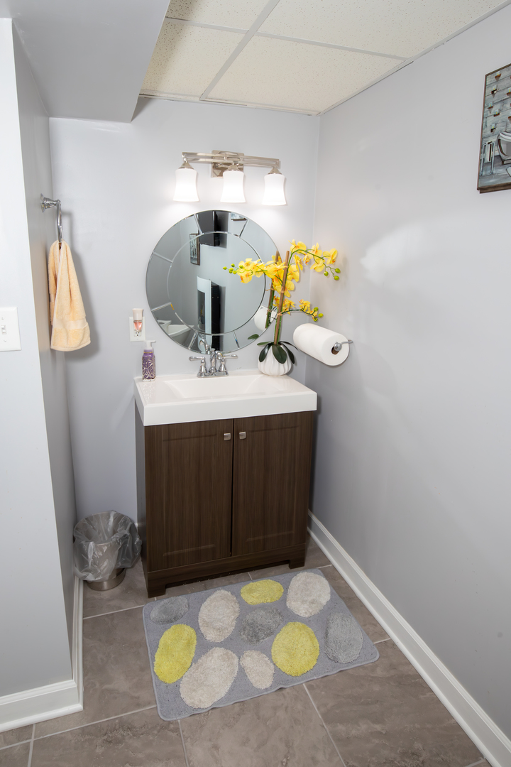 1844 180th Place Lansing, IL 60438 - Photo 31 of 34 a bathroom with a sink toilet and mirror