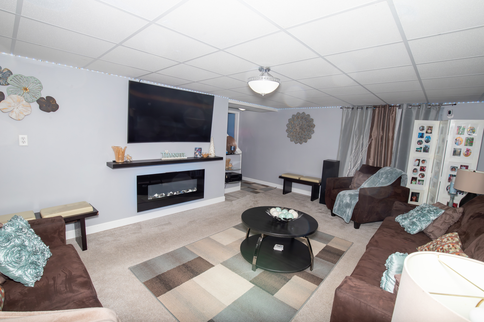 1844 180th Place Lansing, IL 60438 - Photo 32 of 34 a living room with furniture a flat screen tv and a fireplace