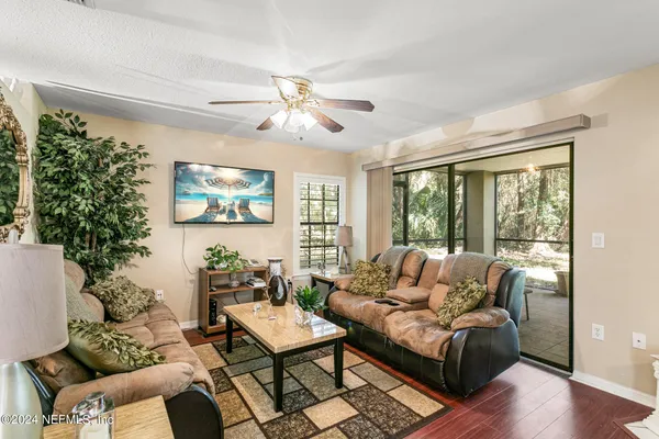 a living room with furniture a fireplace and a chandelier
