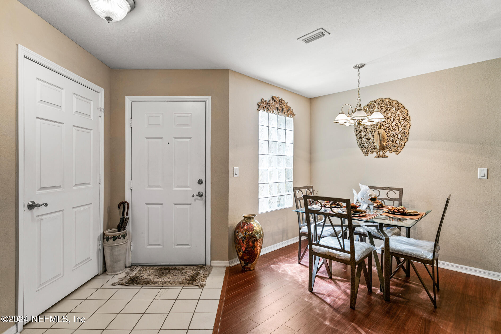 10150 Belle Rive Boulevard, Unit 2605 Jacksonville, FL 32256 - Photo 15 of 52 a view of a dining room with furniture window and wooden floor