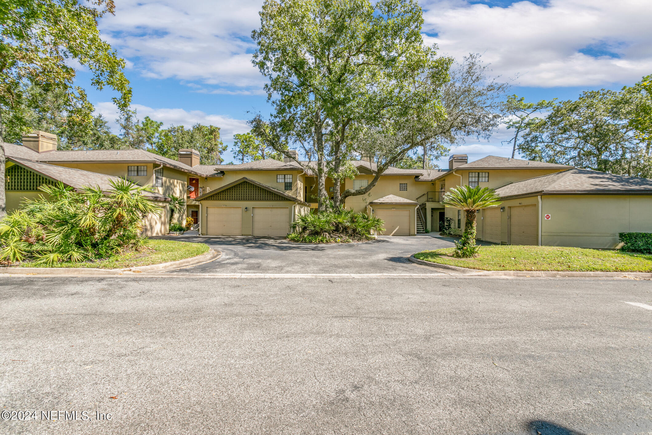 10150 Belle Rive Boulevard, Unit 2605 Jacksonville, FL 32256 - Photo 2 of 52 front view of a house with a yard and a garage