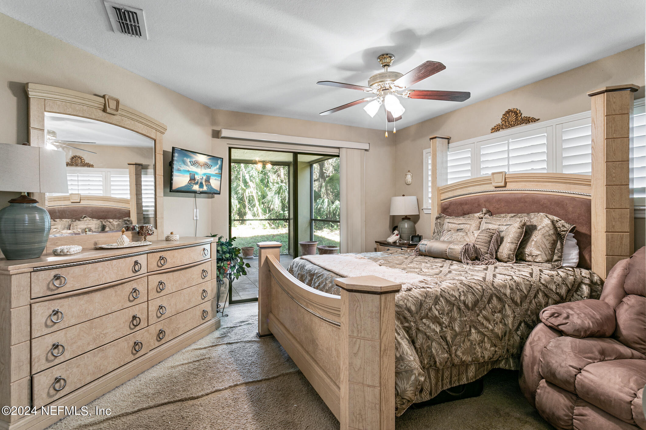 10150 Belle Rive Boulevard, Unit 2605 Jacksonville, FL 32256 - Photo 27 of 52 a bedroom with a bed and a chandelier