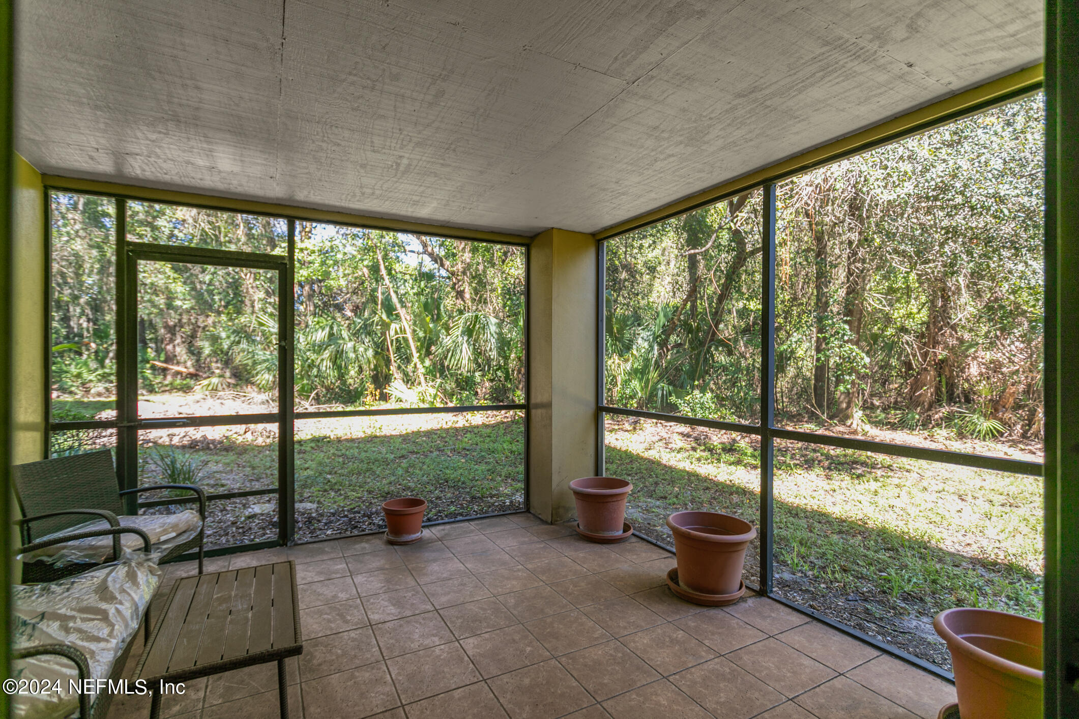 10150 Belle Rive Boulevard, Unit 2605 Jacksonville, FL 32256 - Photo 31 of 52 a living room with furniture and a floor to ceiling window