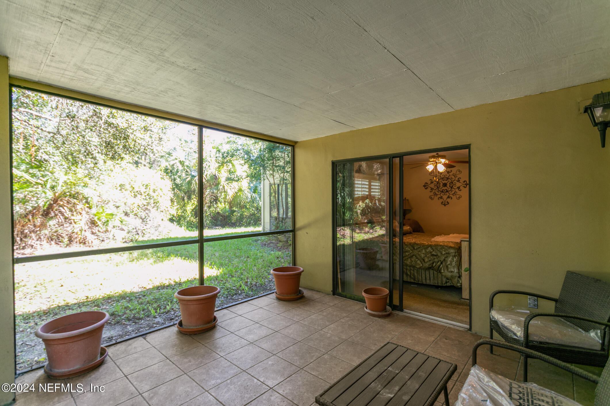 10150 Belle Rive Boulevard, Unit 2605 Jacksonville, FL 32256 - Photo 32 of 52 a living room with a patio
