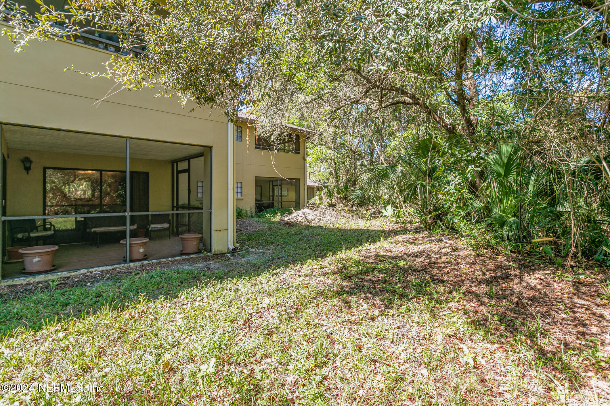 10150 Belle Rive Boulevard, Unit 2605 Jacksonville, FL 32256 - Photo 35 of 52 a view of backyard with tree